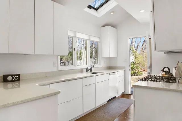 a kitchen with a sink stove and cabinets