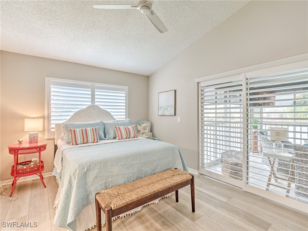 14981 Rivers Edge Court, Unit 228 Fort Myers, FL 33908 - Photo 17 of 40 a bedroom with a bed and wooden floor