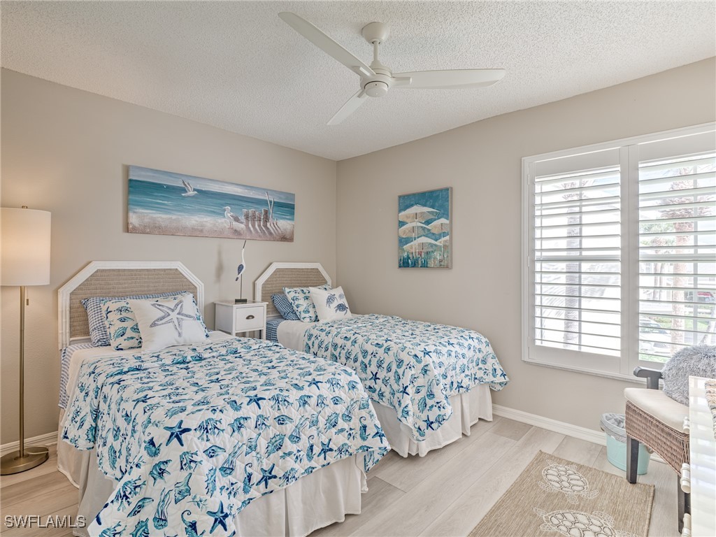 14981 Rivers Edge Court, Unit 228 Fort Myers, FL 33908 - Photo 24 of 40 a bedroom with two beds and a window