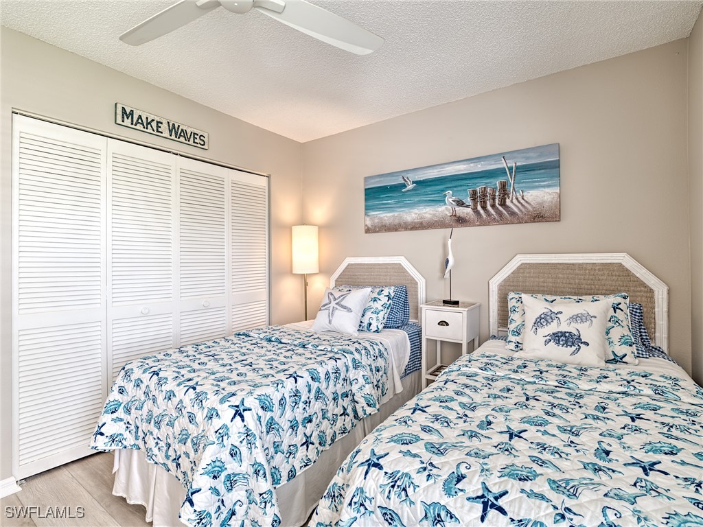 14981 Rivers Edge Court, Unit 228 Fort Myers, FL 33908 - Photo 25 of 40 a bedroom with two beds and a table in it