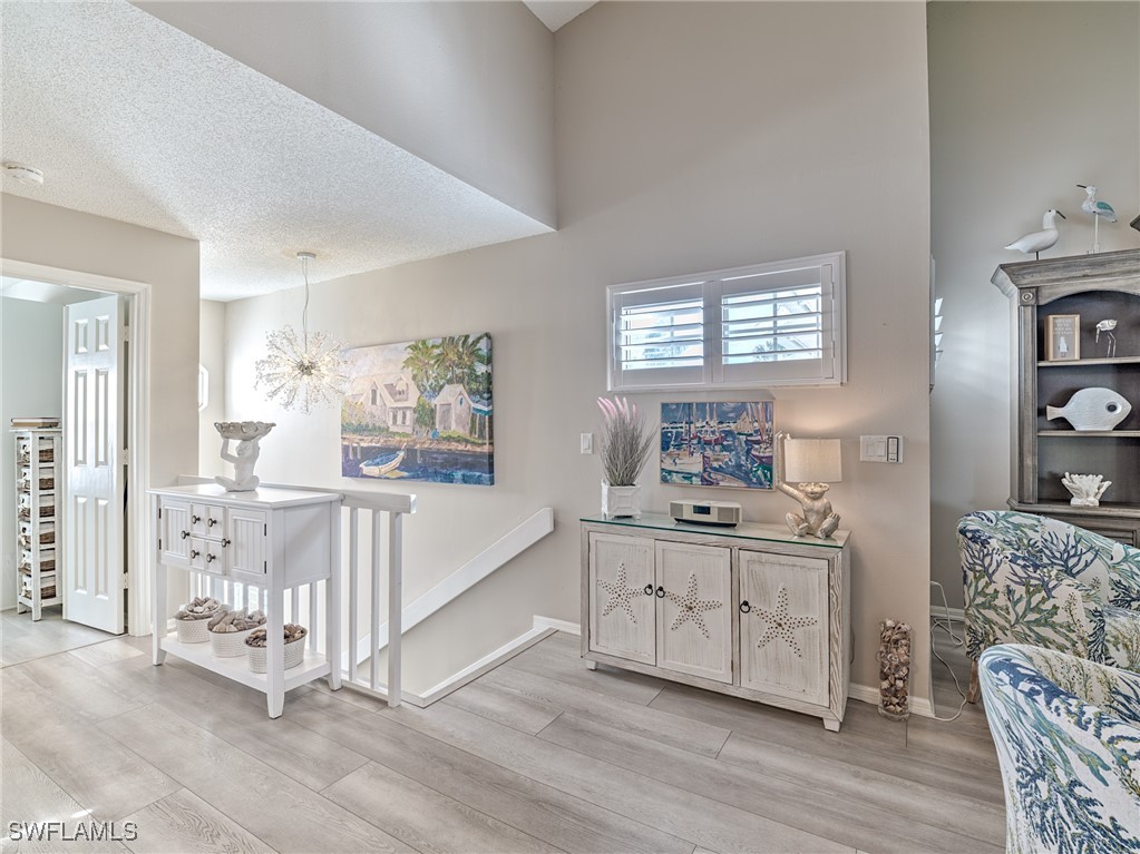 14981 Rivers Edge Court, Unit 228 Fort Myers, FL 33908 - Photo 3 of 40 a spacious bedroom with a bed and a cabinets
