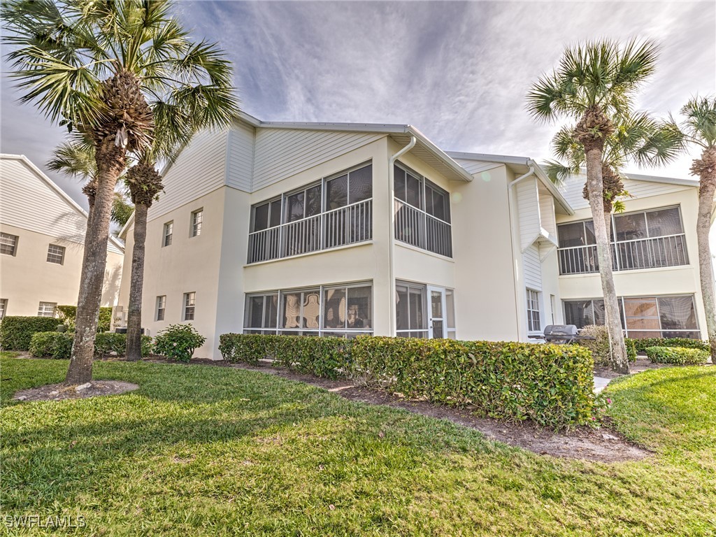 14981 Rivers Edge Court, Unit 228 Fort Myers, FL 33908 - Photo 35 of 40 a view of a building with a garden