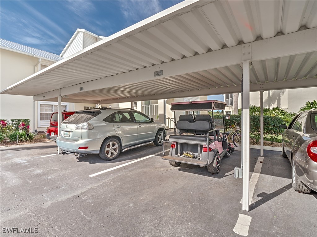 14981 Rivers Edge Court, Unit 228 Fort Myers, FL 33908 - Photo 38 of 40 a view of a garage with parked cars