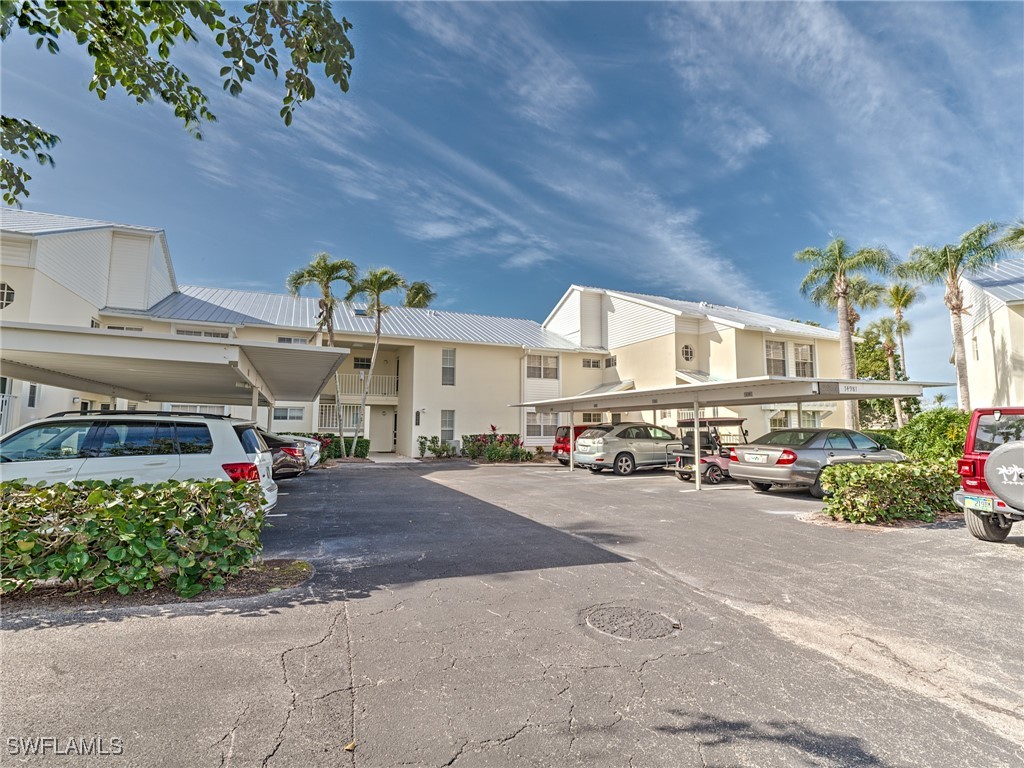 14981 Rivers Edge Court, Unit 228 Fort Myers, FL 33908 - Photo 39 of 40 a view of a garage with cars