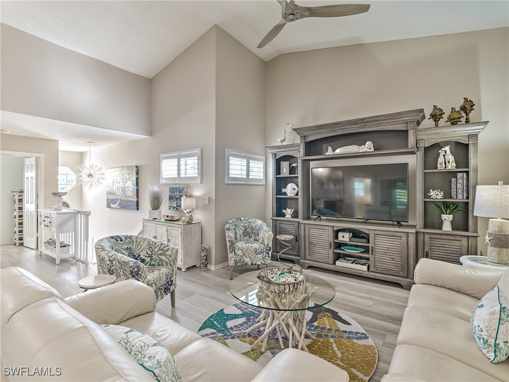 14981 Rivers Edge Court, Unit 228 Fort Myers, FL 33908 - Photo 4 of 40 a living room with furniture and a flat screen tv