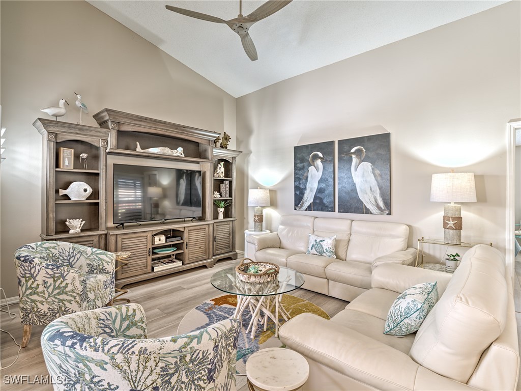 14981 Rivers Edge Court, Unit 228 Fort Myers, FL 33908 - Photo 6 of 40 a living room with furniture and a flat screen tv