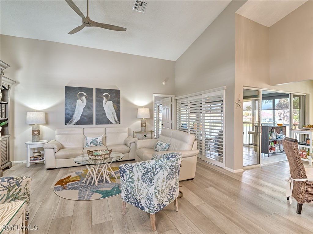 14981 Rivers Edge Court, Unit 228 Fort Myers, FL 33908 - Photo 7 of 40 a living room with furniture and a large window
