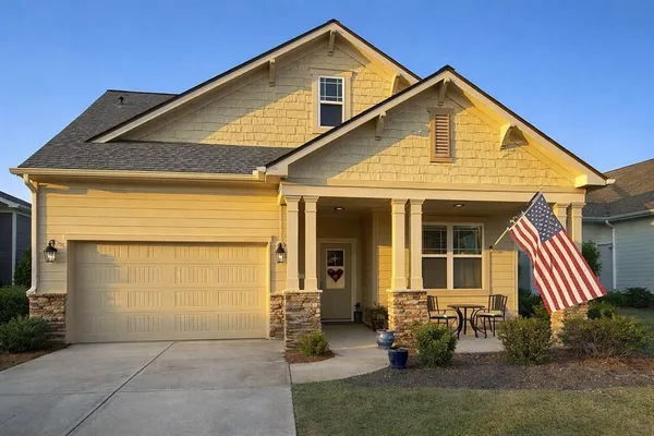 a front view of a house with garden