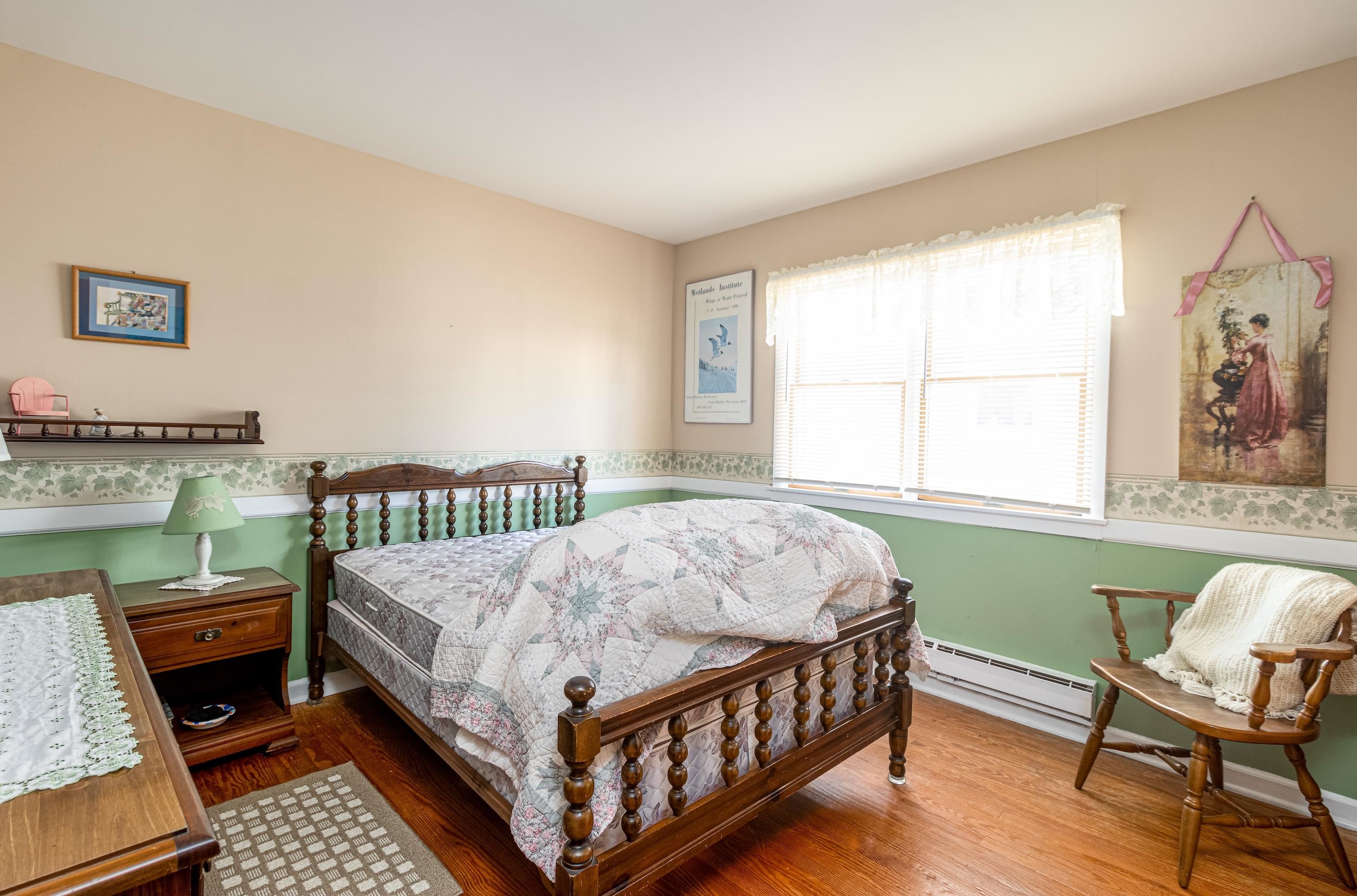 1745 1st Avalon, NJ 08202 - Photo 11 of 17 a bed sitting in a bedroom next to a window
