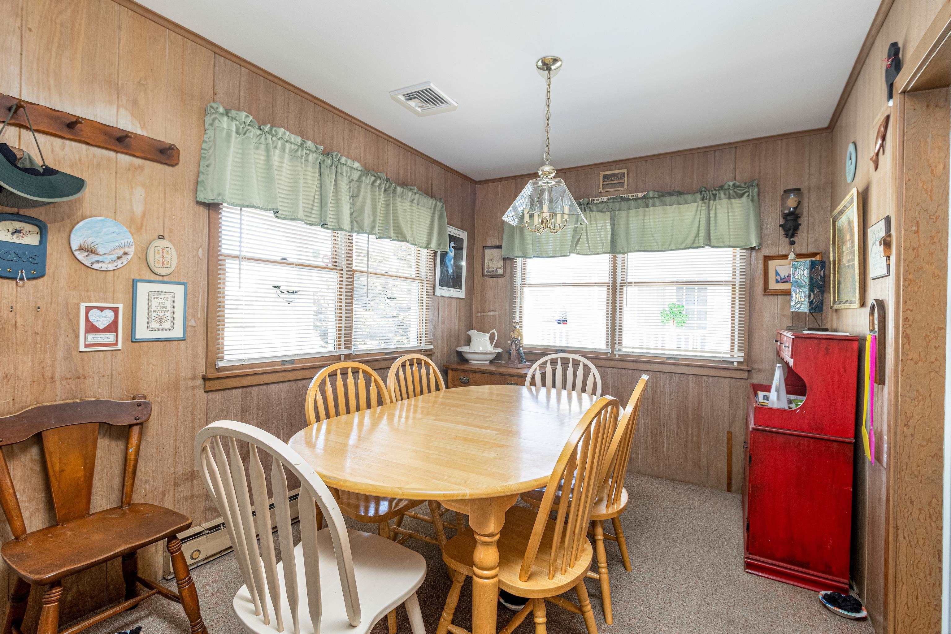 1745 1st Avalon, NJ 08202 - Photo 9 of 17 a dining room with furniture a chandelier and window