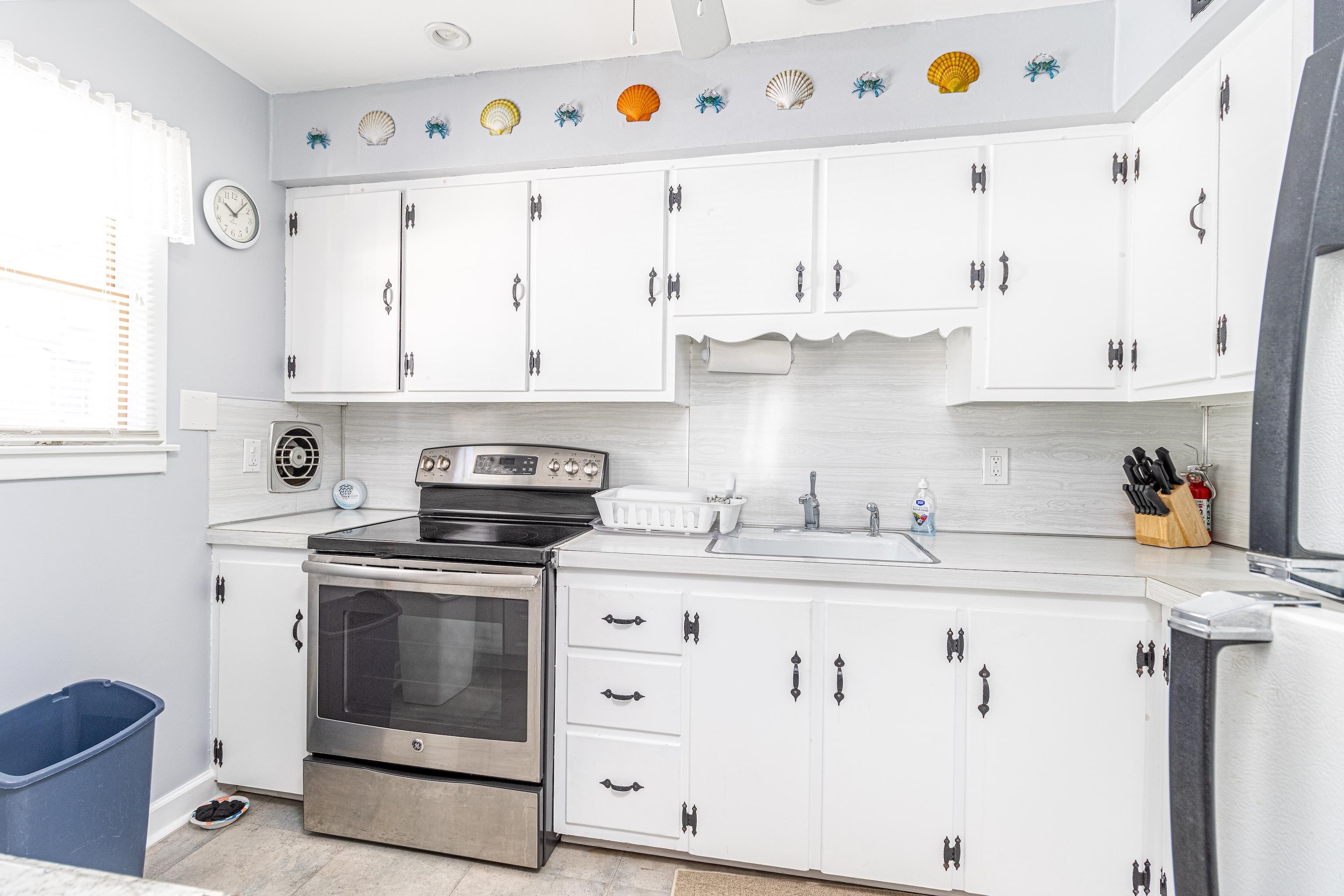 1745 1st Avalon, NJ 08202 - Photo 10 of 17 a kitchen with granite countertop white cabinets and white appliances