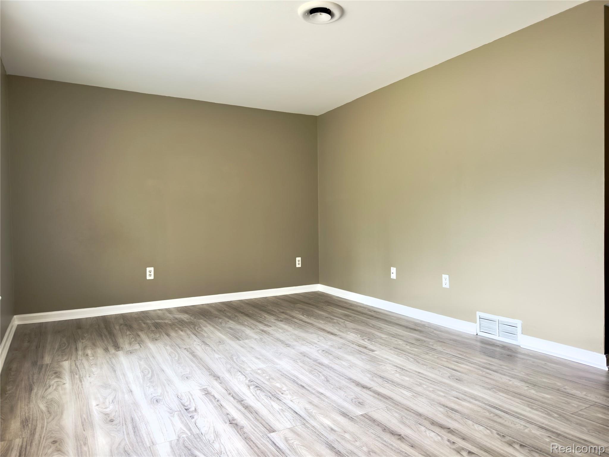 308 North Rochester Road Clawson, MI 48017 - Photo 7 of 16 Spacious room featuring pristine wood-finish flooring, neutral wall tones, and recessed ceiling lighting