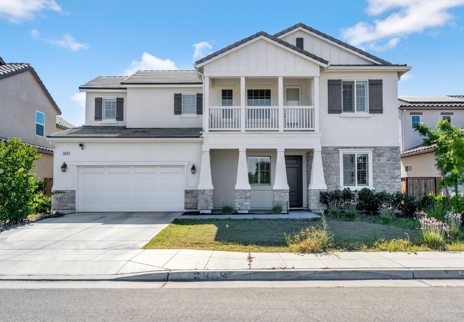 2468 Montana Avenue Clovis, CA 93619 - Photo 1 of 33 a front view of a house with a yard