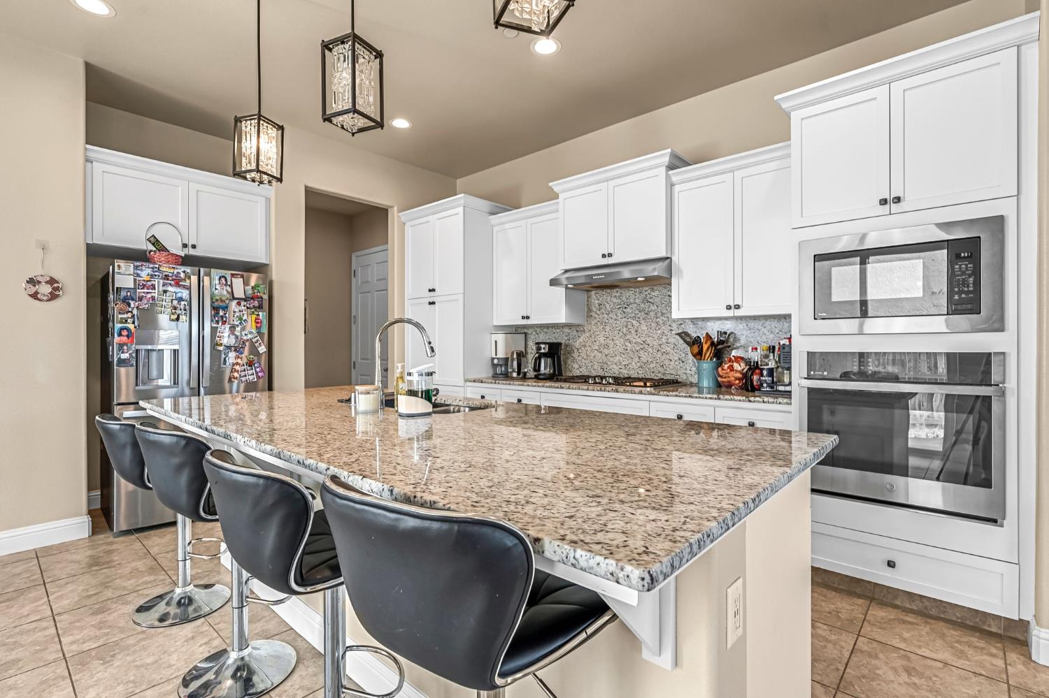 2468 Montana Avenue Clovis, CA 93619 - Photo 14 of 33 a kitchen with stainless steel appliances granite countertop a sink a stove and cabinets