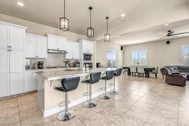 a large kitchen with cabinets and stainless steel appliances