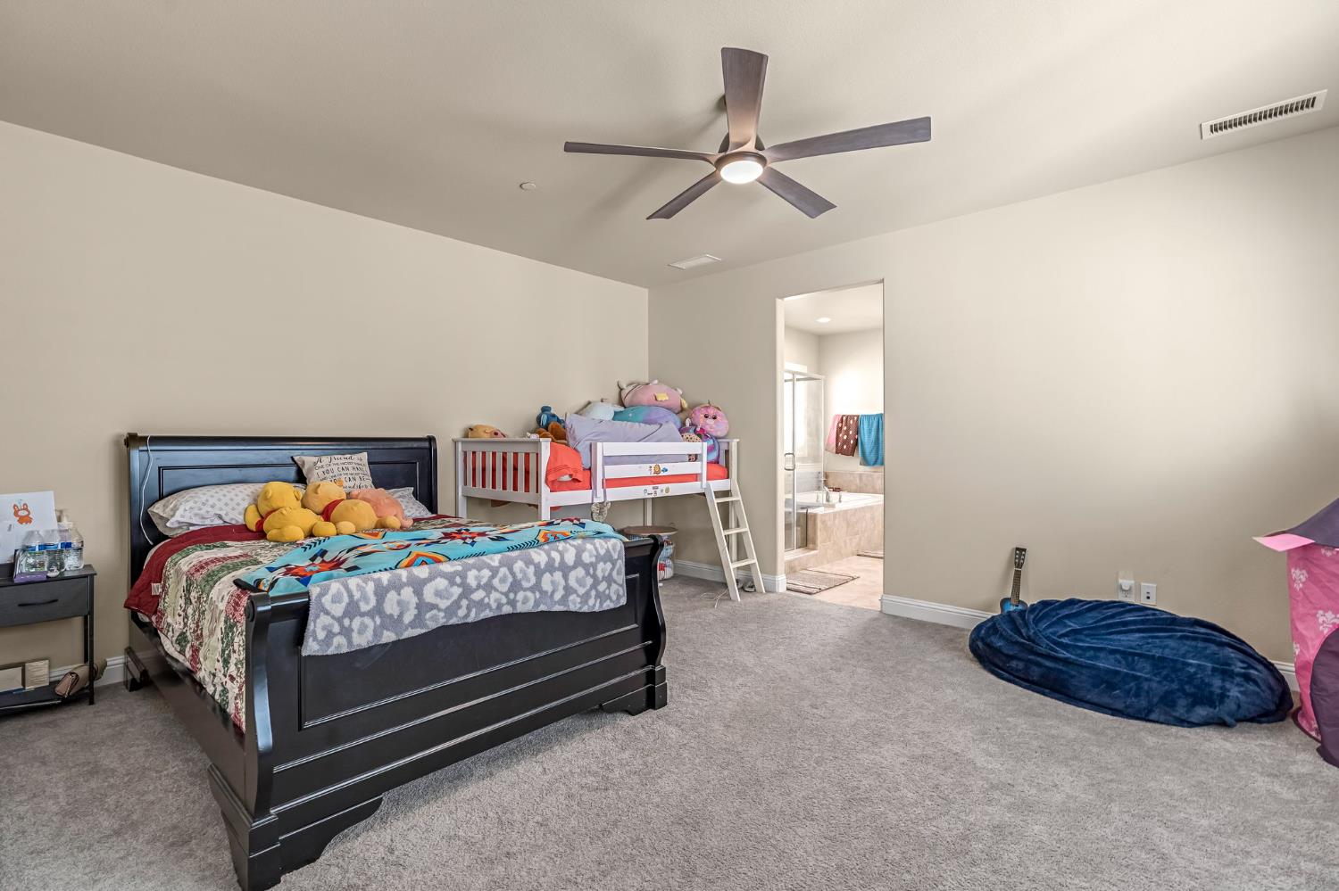 2468 Montana Avenue Clovis, CA 93619 - Photo 21 of 33 a bedroom with a bed a dresser and window
