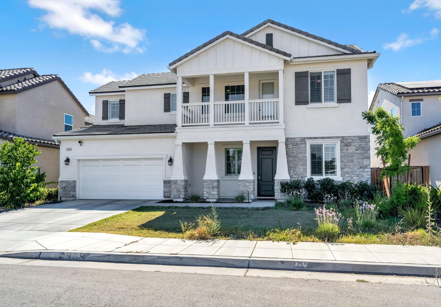 2468 Montana Avenue Clovis, CA 93619 - Photo 3 of 33 a front view of a house with a yard and potted plants