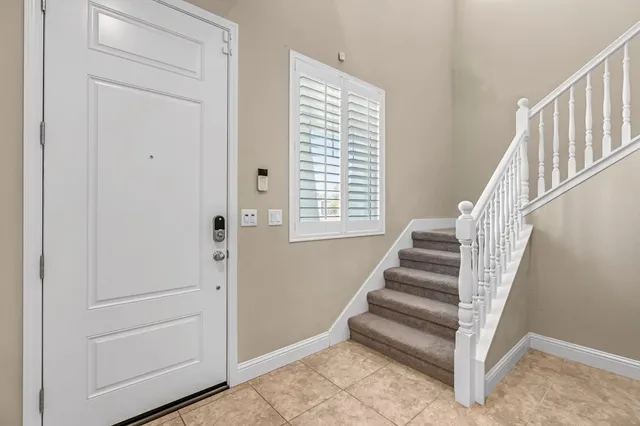 a view of entryway with stairs and wooden floor
