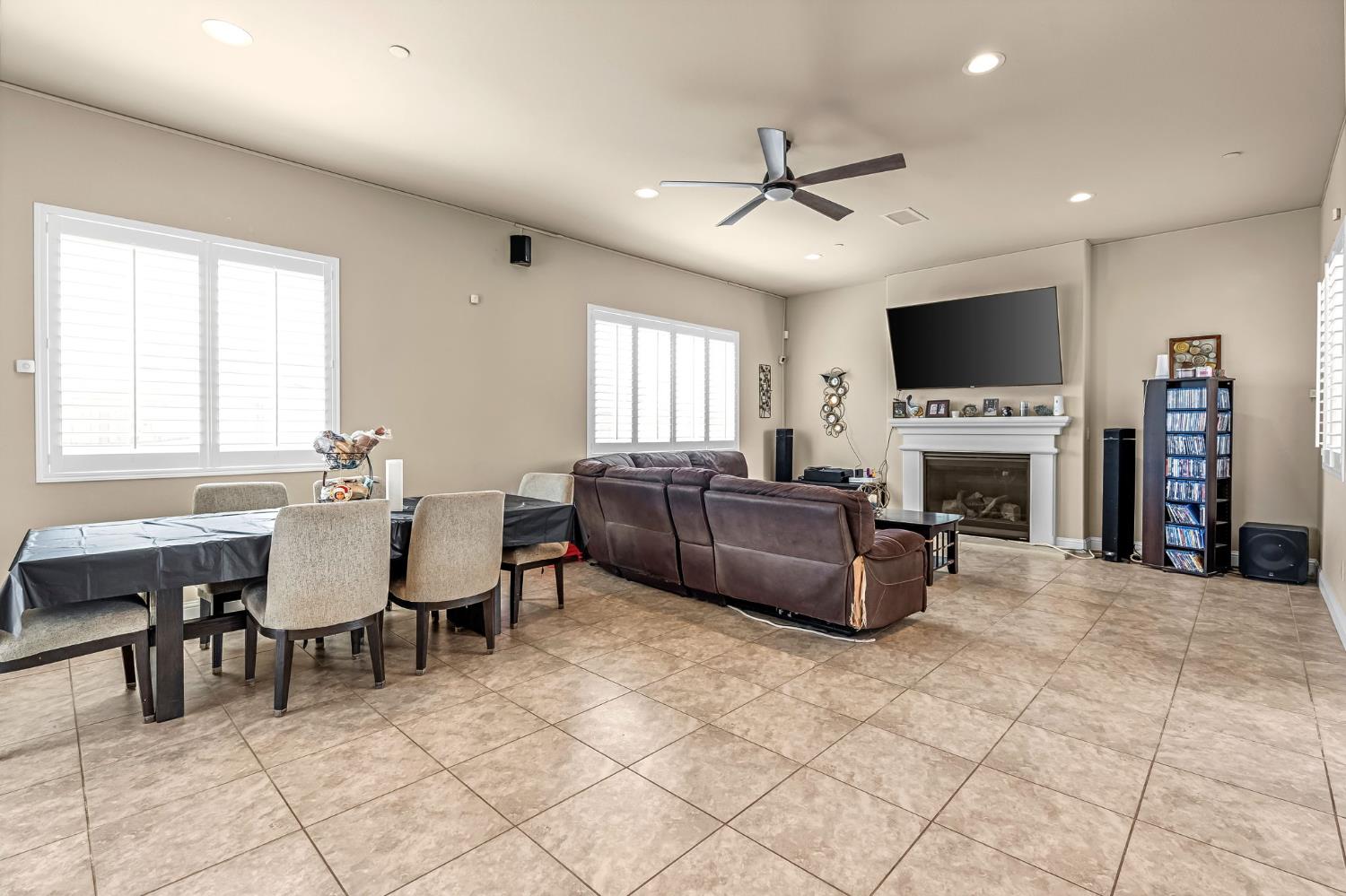 2468 Montana Avenue Clovis, CA 93619 - Photo 6 of 33 a living room with furniture a fireplace and a flat screen tv