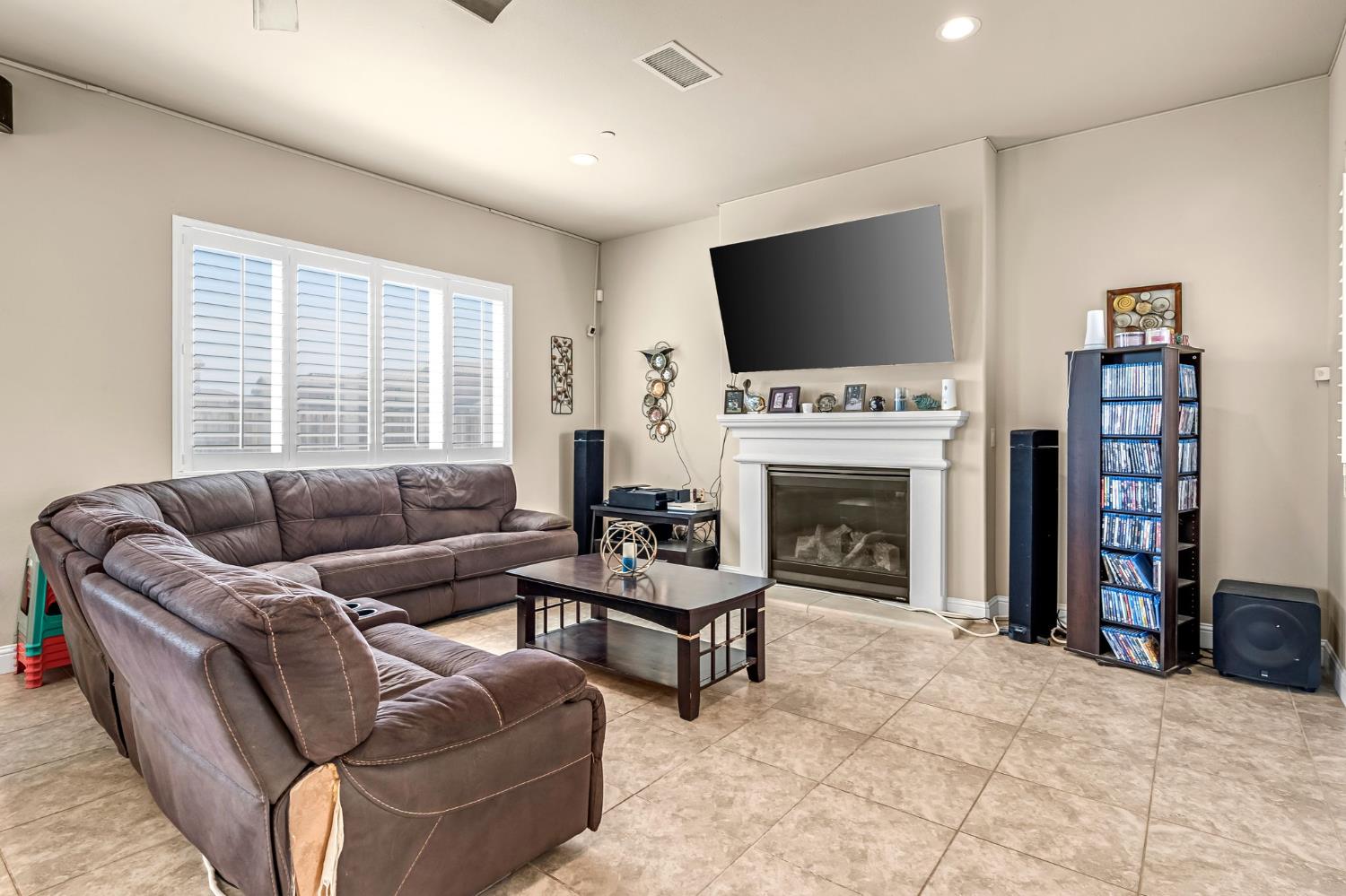 2468 Montana Avenue Clovis, CA 93619 - Photo 7 of 33 a living room with furniture a flat screen tv and a fireplace