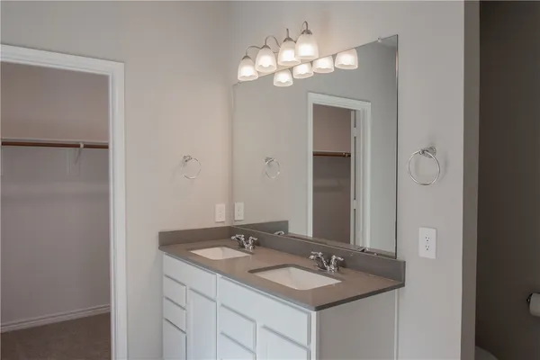 a bathroom with a sink vanity and a mirror