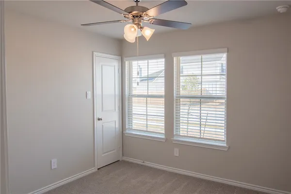 a view of a bathroom from the door
