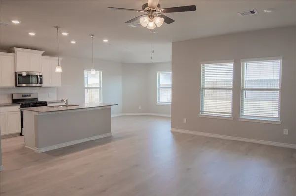 a view of kitchen with sink and microwave