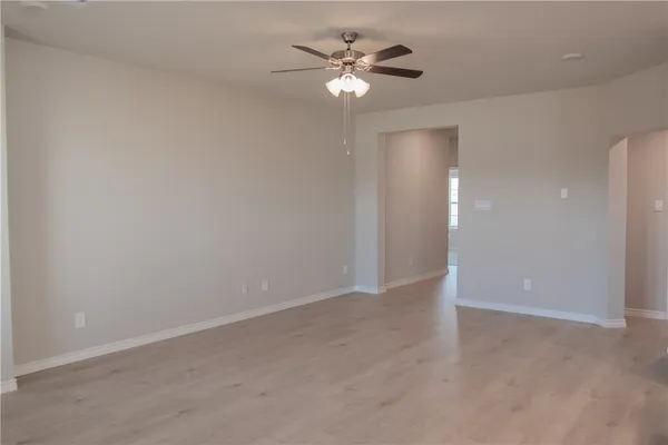 an empty room with fan and a ceiling fan