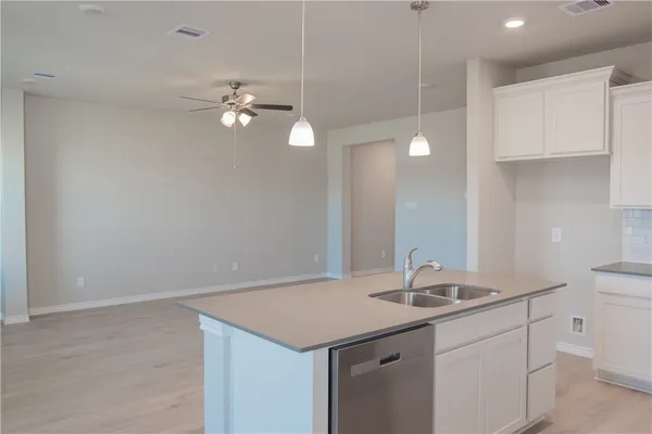 a kitchen with kitchen island a sink stainless steel appliances and cabinets