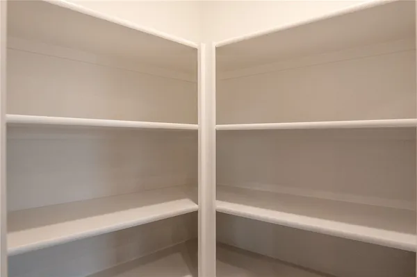 a kitchen with white cabinets and black appliances
