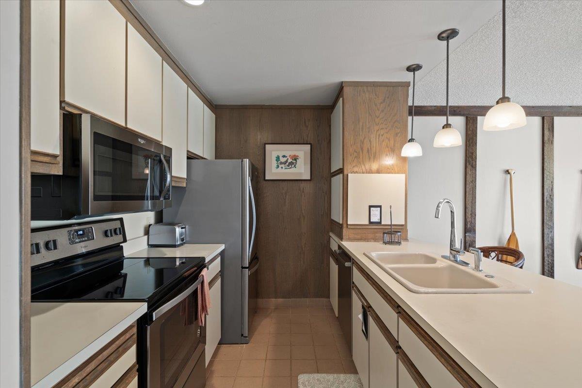 101 Shell Road, Unit 211 Watsonville, CA 95076 - Photo 11 of 29 a kitchen with stainless steel appliances a stove sink and microwave