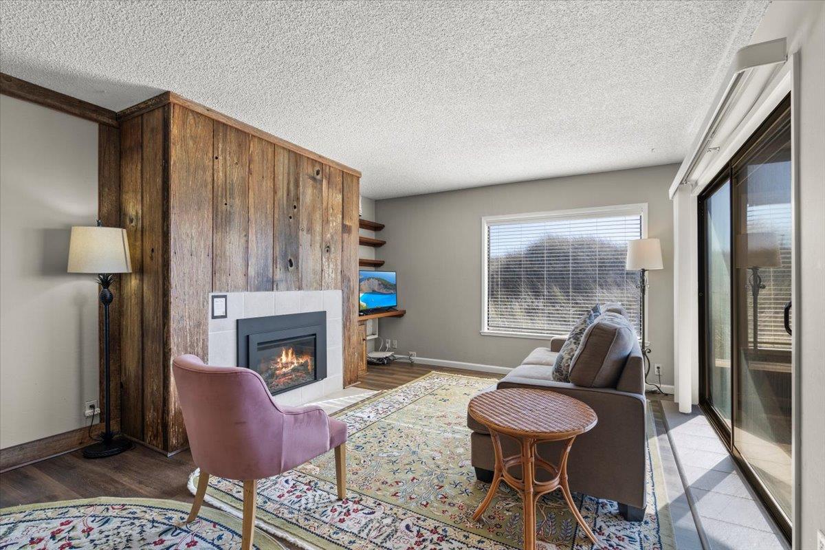 101 Shell Road, Unit 211 Watsonville, CA 95076 - Photo 2 of 29 a living room with furniture and a fireplace