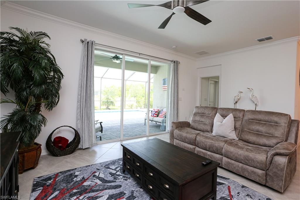 2155 Hamlin Street Naples, FL 34120 - Photo 49 of 50 Tiled living room featuring ceiling fan and ornamental molding
