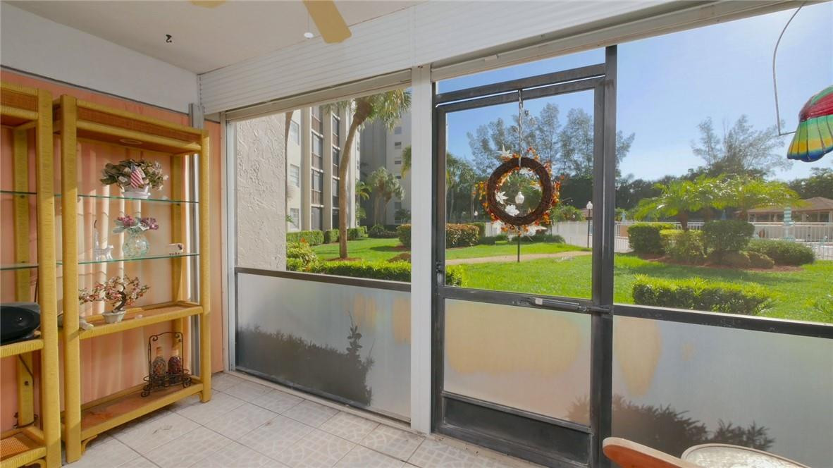 a view of a porch with furniture and garden