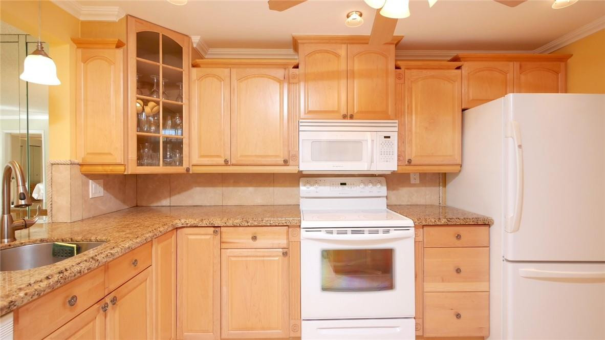 3930 Inverrary Boulevard, Unit 105D Lauderhill, FL 33319 - Photo 11 of 46 a kitchen with a refrigerator stove and sink