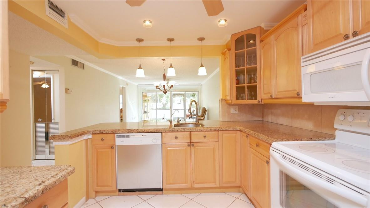 3930 Inverrary Boulevard, Unit 105D Lauderhill, FL 33319 - Photo 13 of 46 a kitchen with a sink and cabinets