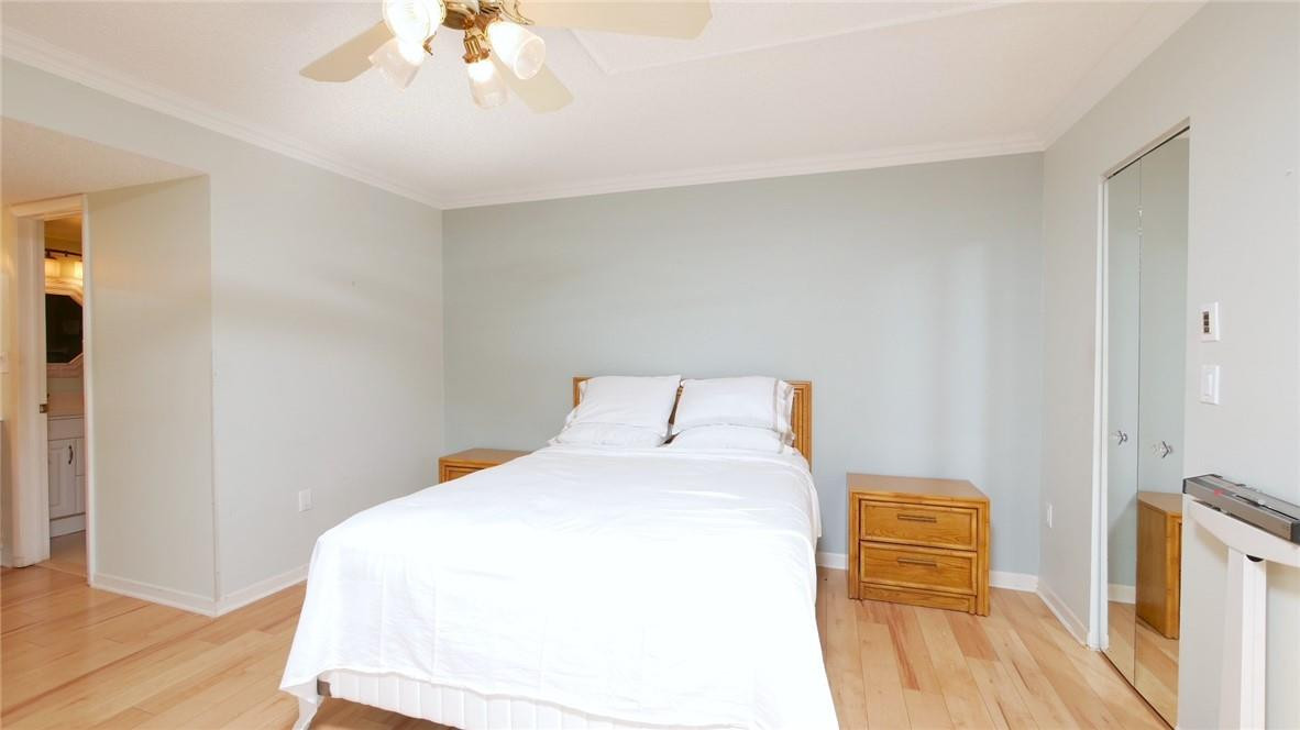 3930 Inverrary Boulevard, Unit 105D Lauderhill, FL 33319 - Photo 17 of 46 a bedroom with a bed and a chandelier