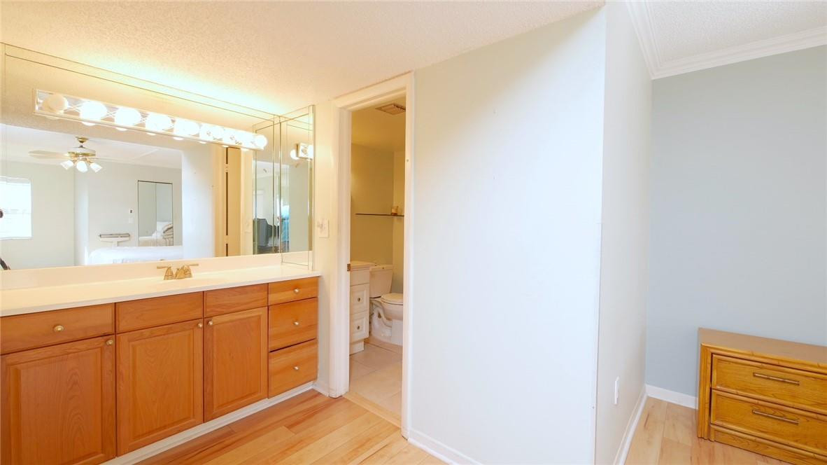 3930 Inverrary Boulevard, Unit 105D Lauderhill, FL 33319 - Photo 19 of 46 a spacious bathroom with a double vanity sink and a mirror