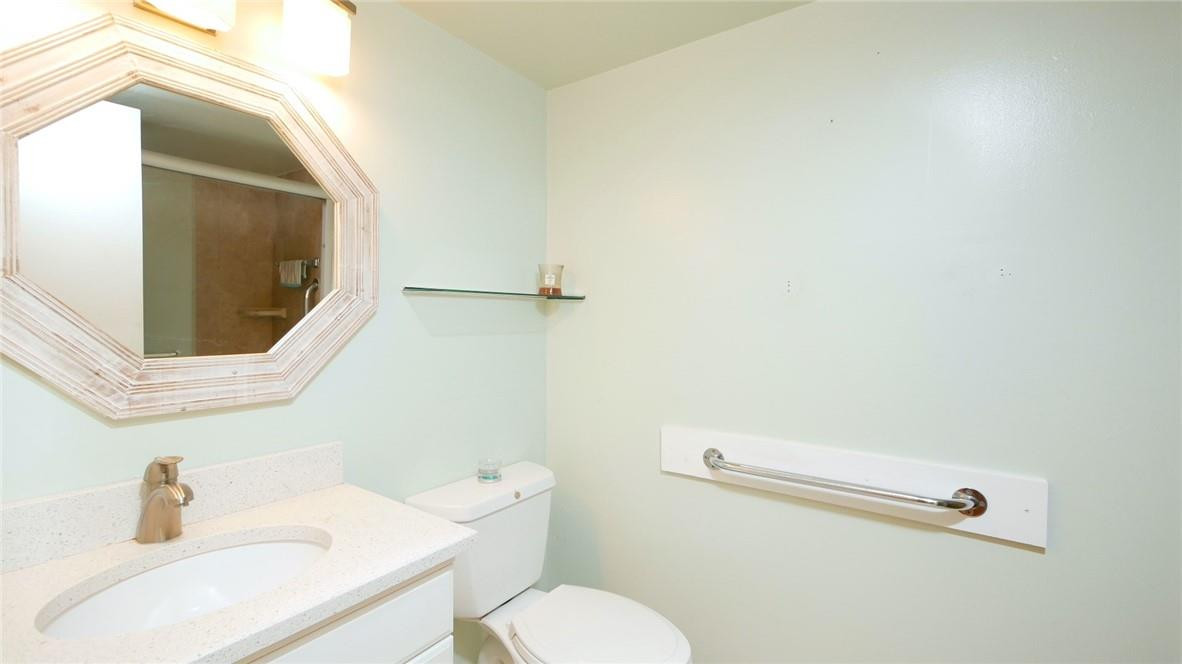 3930 Inverrary Boulevard, Unit 105D Lauderhill, FL 33319 - Photo 21 of 46 a bathroom with a toilet sink and mirror