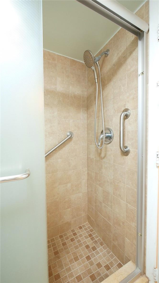 3930 Inverrary Boulevard, Unit 105D Lauderhill, FL 33319 - Photo 22 of 46 a bathroom with a glass shower door
