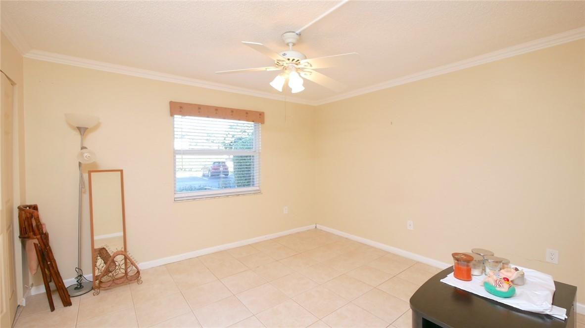 3930 Inverrary Boulevard, Unit 105D Lauderhill, FL 33319 - Photo 26 of 46 a view of a livingroom with wooden floor and a ceiling fan