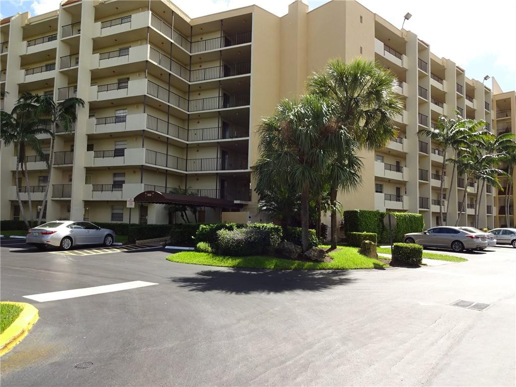 3930 Inverrary Boulevard, Unit 105D Lauderhill, FL 33319 - Photo 38 of 46 a front view of a building with cars parked