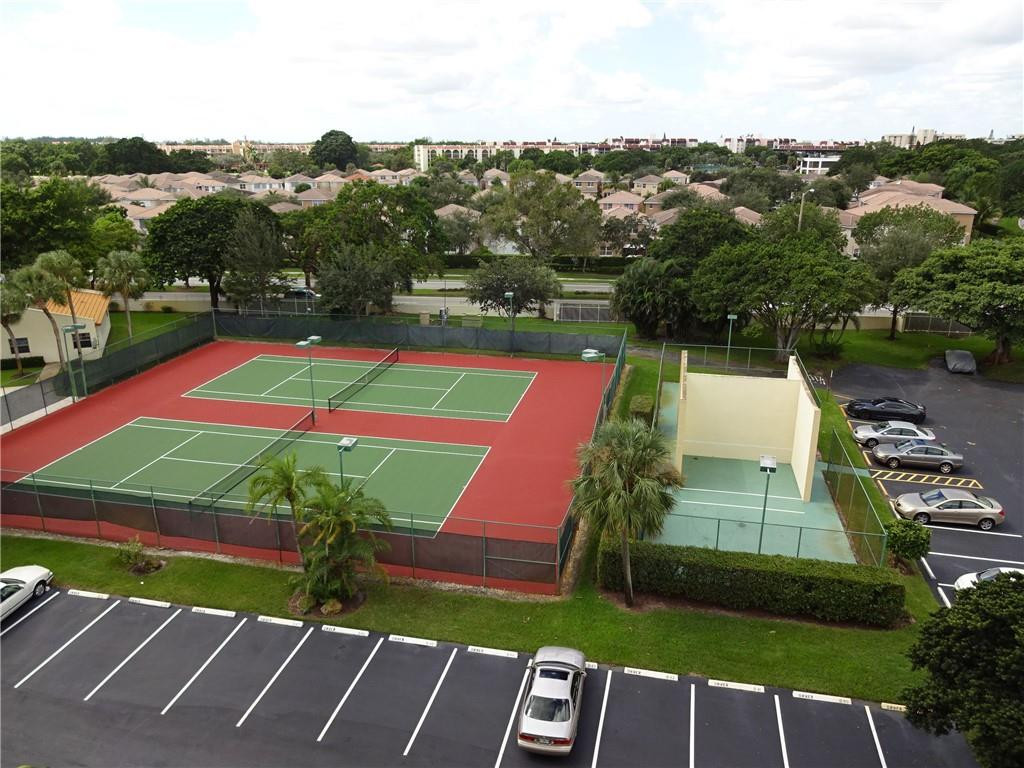 3930 Inverrary Boulevard, Unit 105D Lauderhill, FL 33319 - Photo 39 of 46 an aerial view of a tennis ground and a cars park side of the road