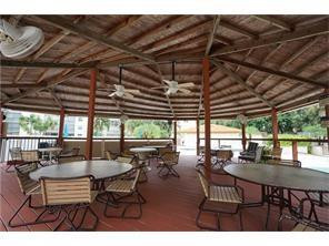 3930 Inverrary Boulevard, Unit 105D Lauderhill, FL 33319 - Photo 44 of 46 a view of a patio with table and chairs with wooden floor