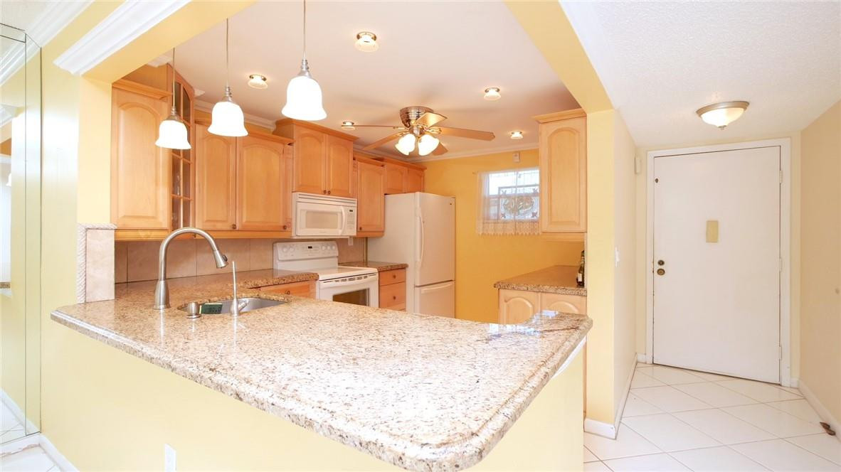 3930 Inverrary Boulevard, Unit 105D Lauderhill, FL 33319 - Photo 8 of 46 a bathroom with a sink vanity and a mirror