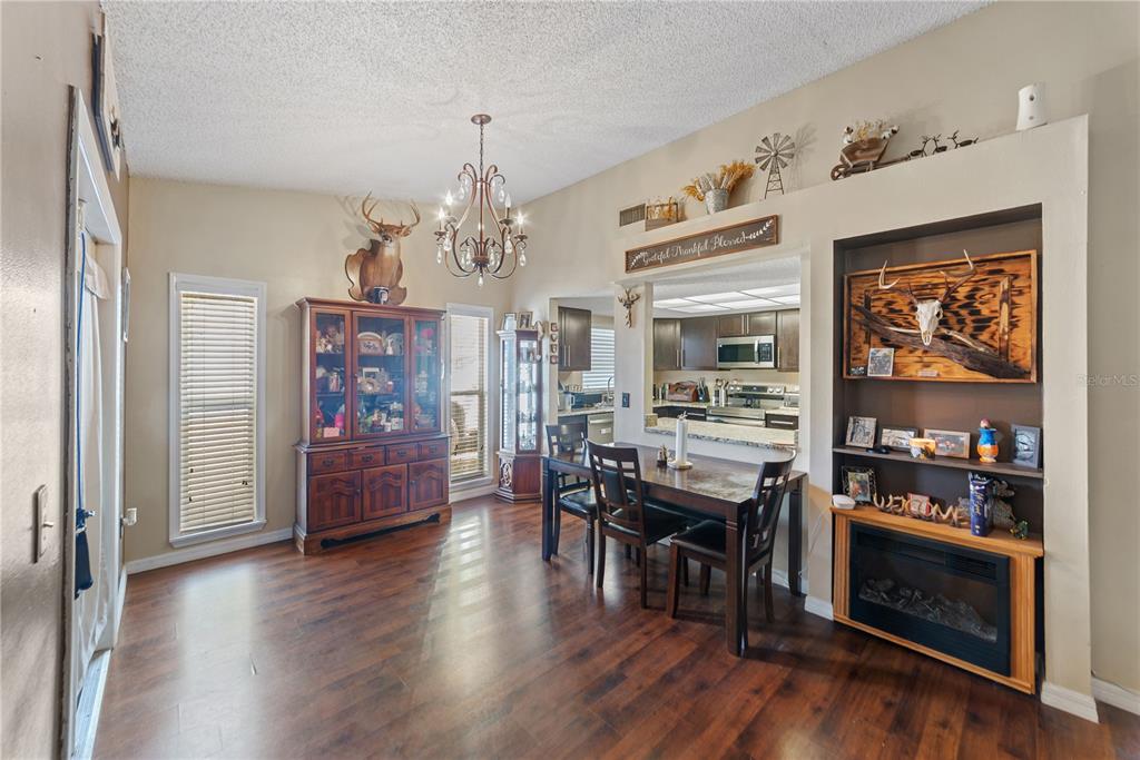 8715 Huntsman Lane Port Richey, FL 34668 - Photo 17 of 54 a view of a dining room with furniture and wooden floor
