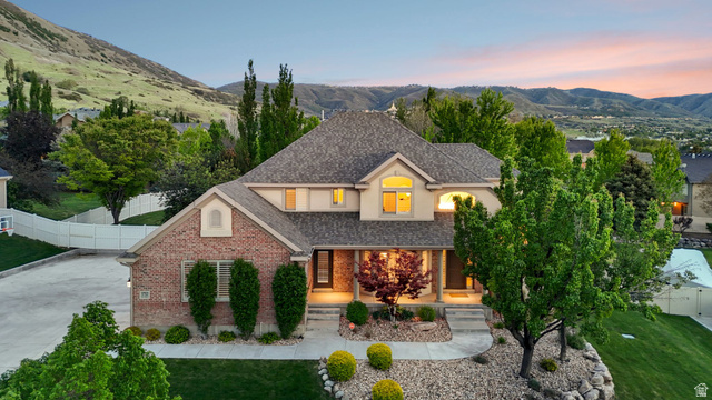 Brick and stucco exterior with a prominent front entrance featuring a covered porch