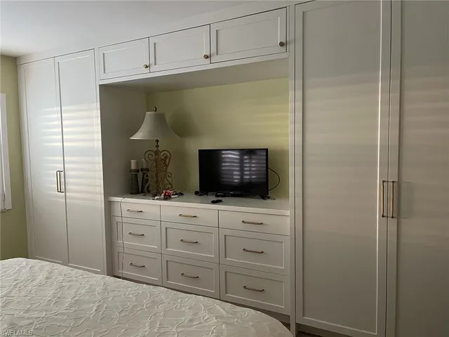 a living room with vanity and flat screen tv