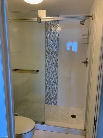 a bathroom with a shower and a toilet