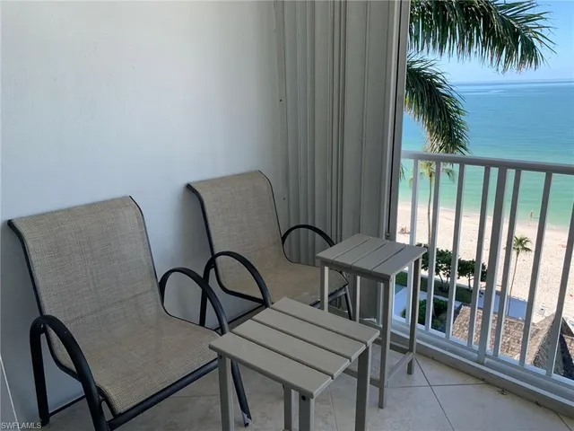 a balcony with table and chairs